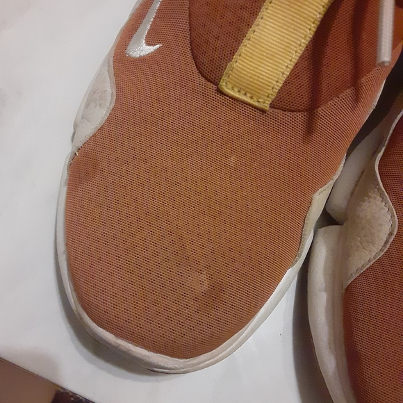 A pair of Nike sneakers. - Picture 2 of 4